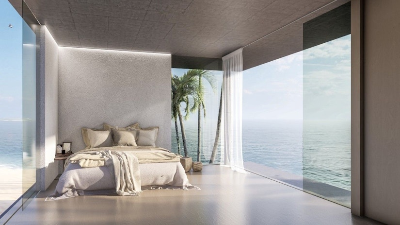 Ein Hotelzimmer mit Bett und Aussicht aufs Meer.